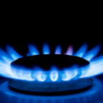Gas burner blue flames on dark black background
