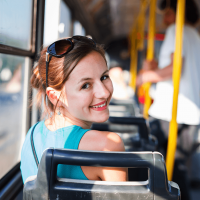 Female commuter on bus looking over shoulder