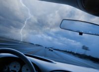 Looking through car windshield into lightning storm