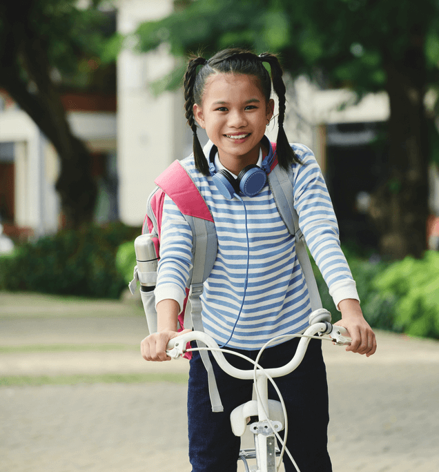 girl riding bike to school
